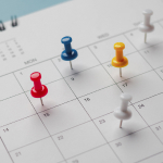 push pins on a calendar