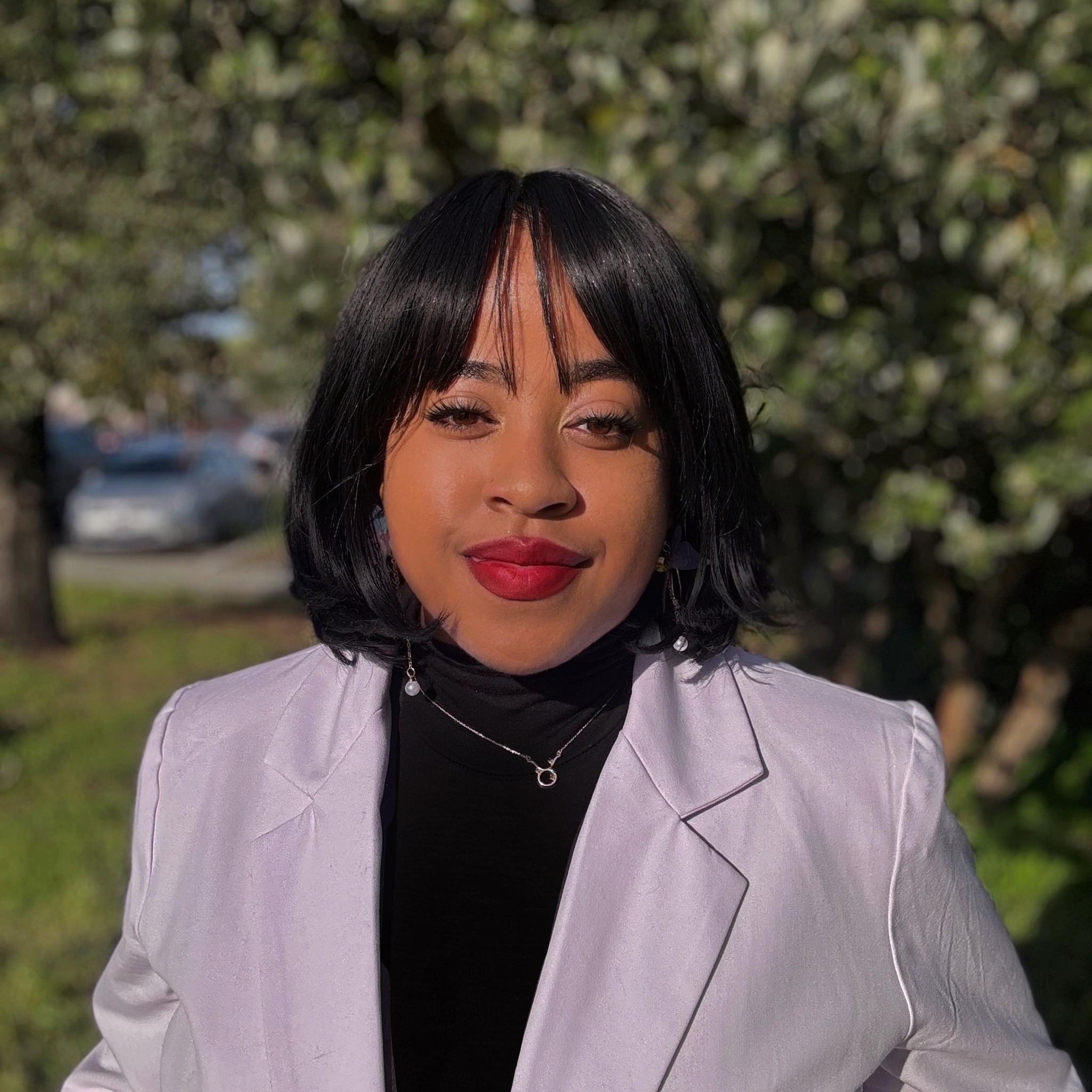 an individual outside with a purple blazer