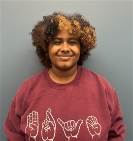 individual with an afro smiling