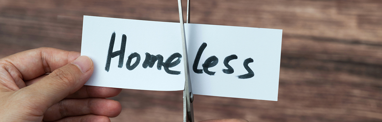 scissors cutting less off of the word homeless