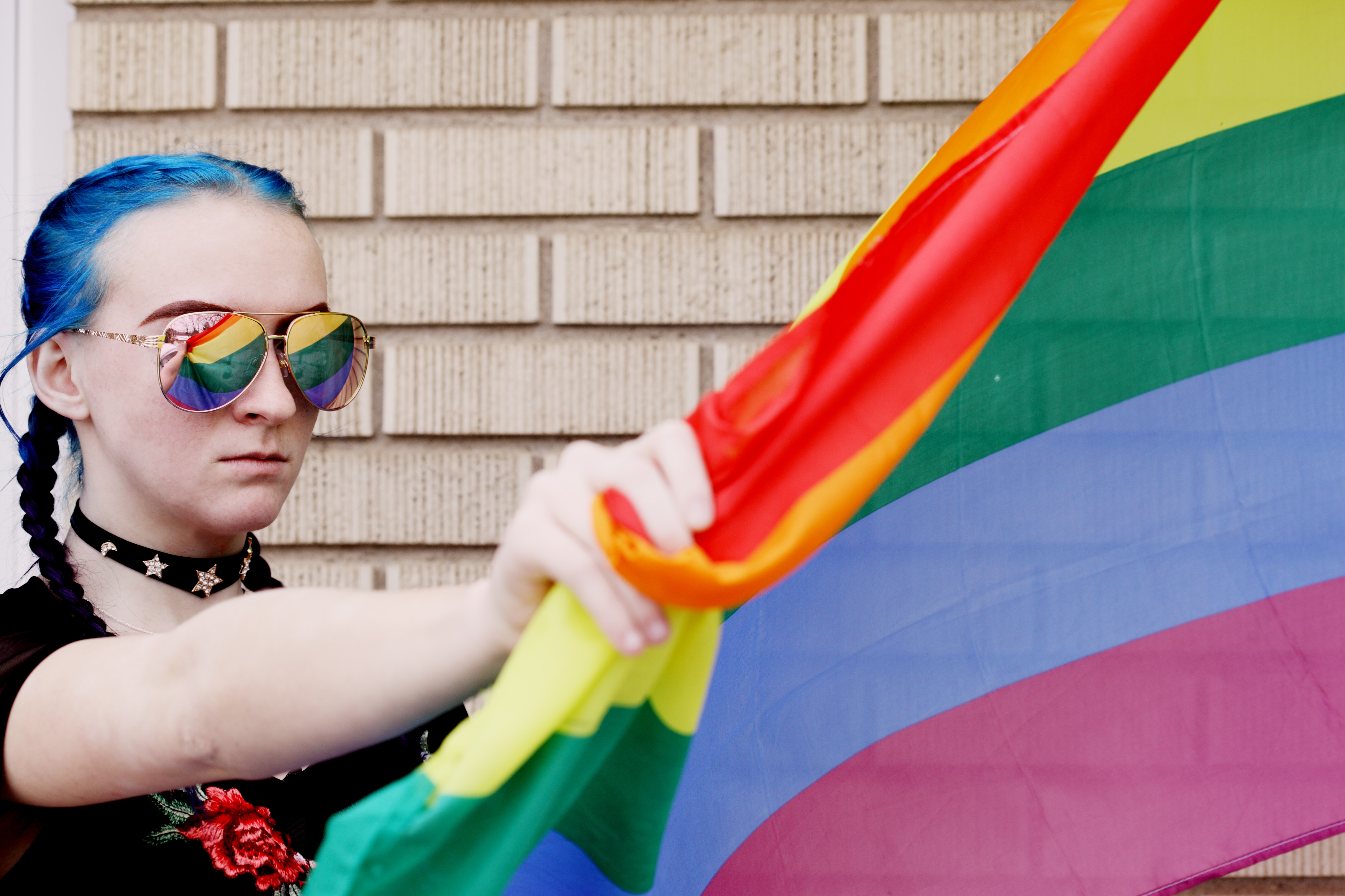 young person with rainbow flag